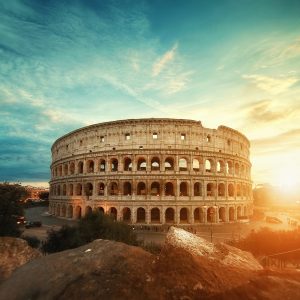 A beautiful shot of the famous Roman Colosseum amphitheater under the breathtaking sky at sunrise